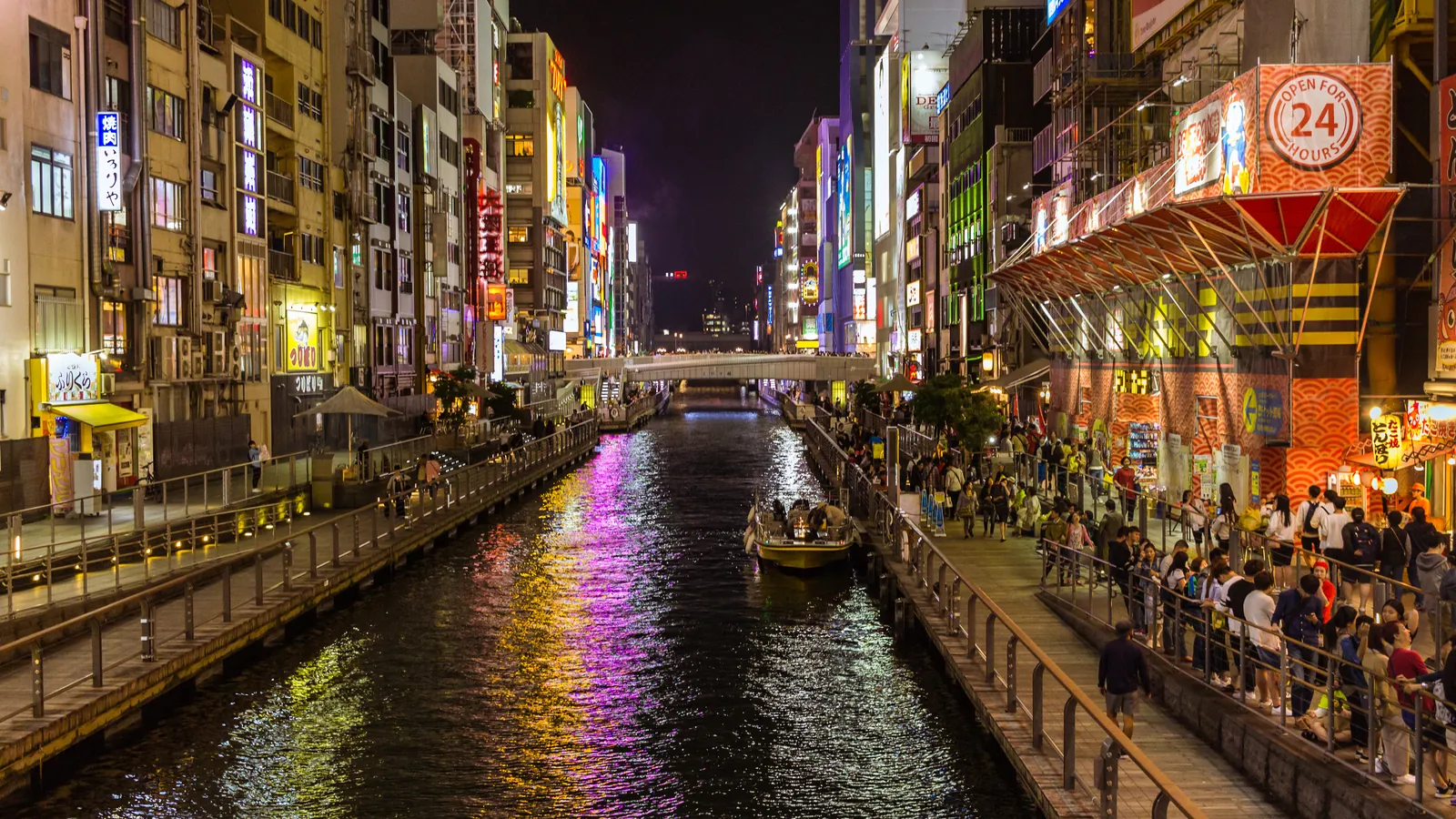 The Dotonbori canal and its illuminated signs at night in Osaka.